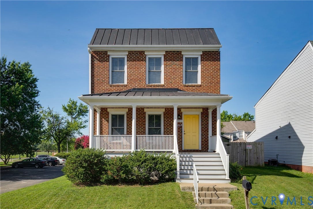 1301 Dance Street, Randolph, Richmond, VA 23220 Brick facade featuring a standing seam metal roof, a covered front porch with white railings, and a bright yellow front door