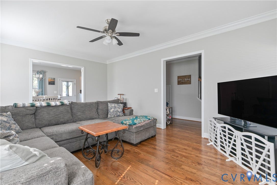 1301 Dance Street, Randolph, Richmond, VA 23220 Living area featuring warm wood-finish flooring, light gray wall paint, and white crown molding