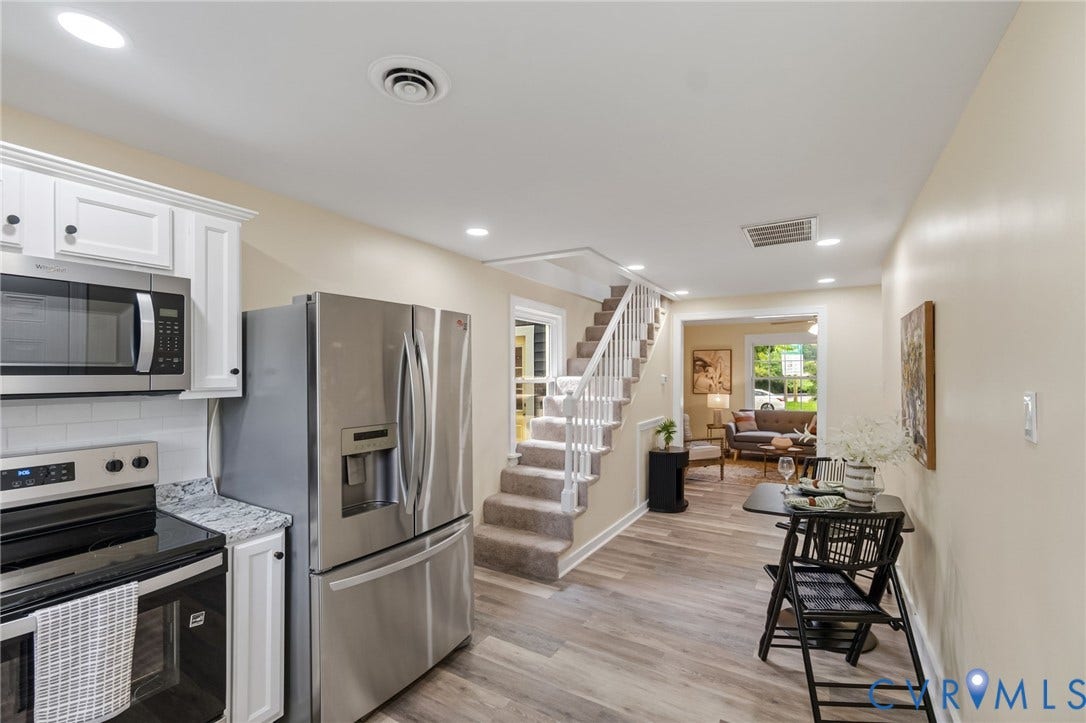 3122 Maplewood Avenue, Stadium, Richmond, VA 23221 Modern kitchen and open living area featuring stainless steel appliances, white cabinetry, wood-finish flooring throughout, recessed lighting, and a central island with seating