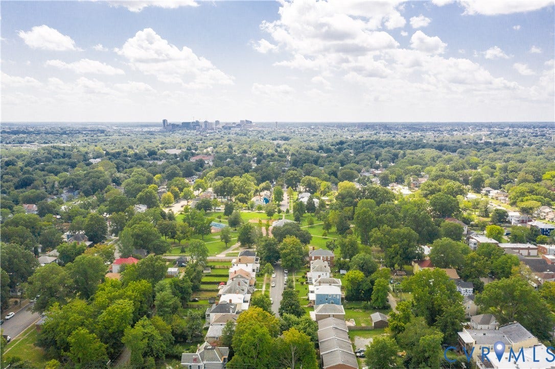 Expansive aerial perspective showcasing a neighborhood with mature tree canopies