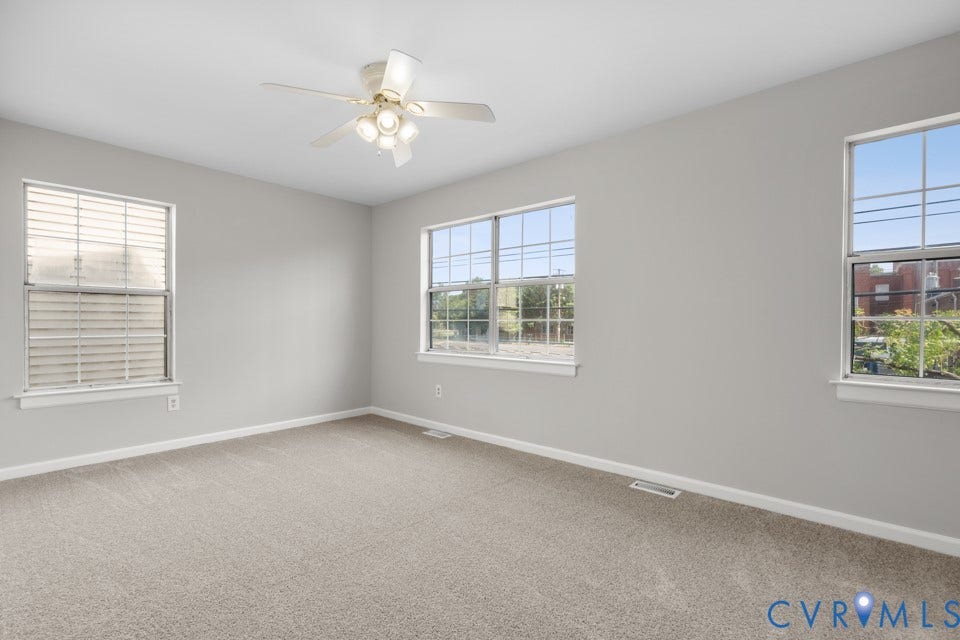 1409 Idlewood Avenue, Randolph, Richmond, VA 23220 Spacious bedroom featuring new carpeting, light gray wall paint, and white trim and lots of windows and light