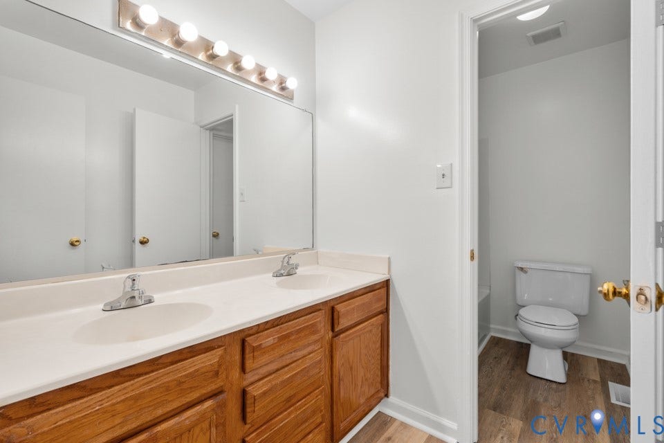 1409 Idlewood Avenue, Randolph, Richmond, VA 23220 Double vanity featuring a light-toned countertop, dual integrated sinks, and chrome faucets