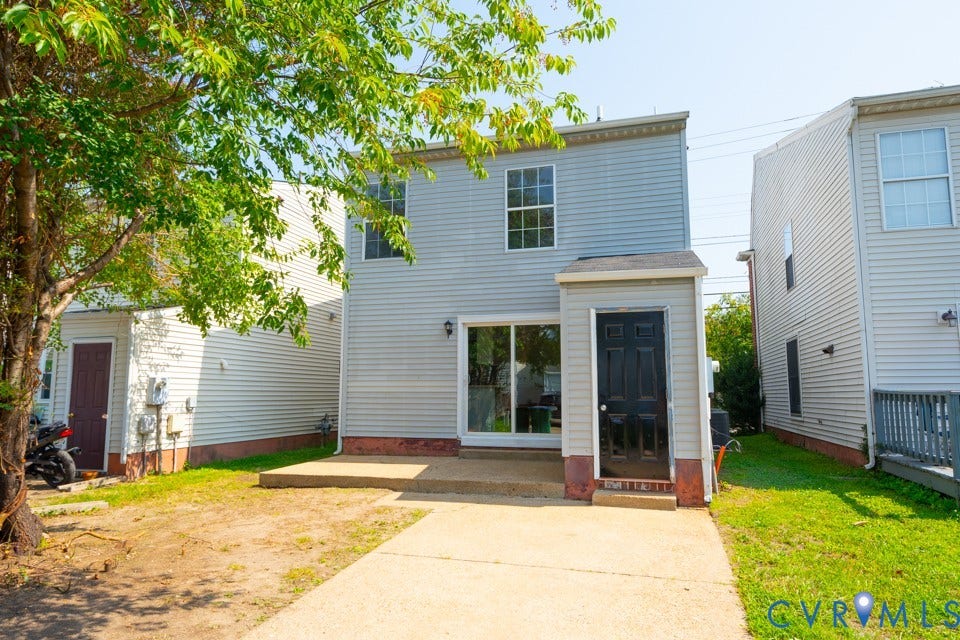 1409 Idlewood Avenue, Randolph, Richmond, VA 23220 Rear exterior featuring light-colored siding, a concrete patio, and a sliding glass door