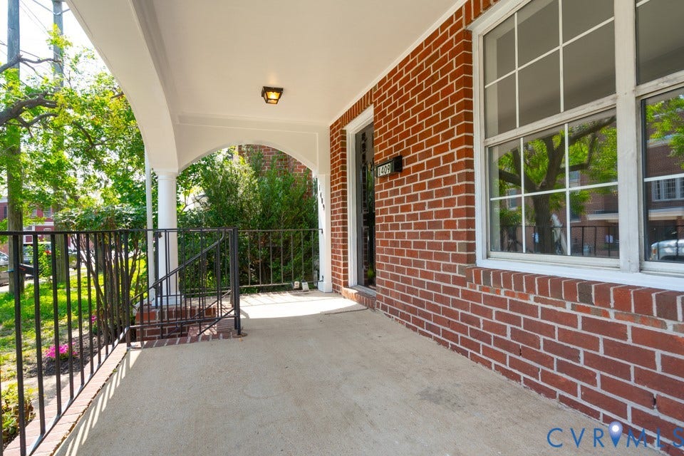 1409 Idlewood Avenue, Randolph, Richmond, VA 23220 Covered front porch featuring a concrete floor, black wrought iron railing, and brick facade