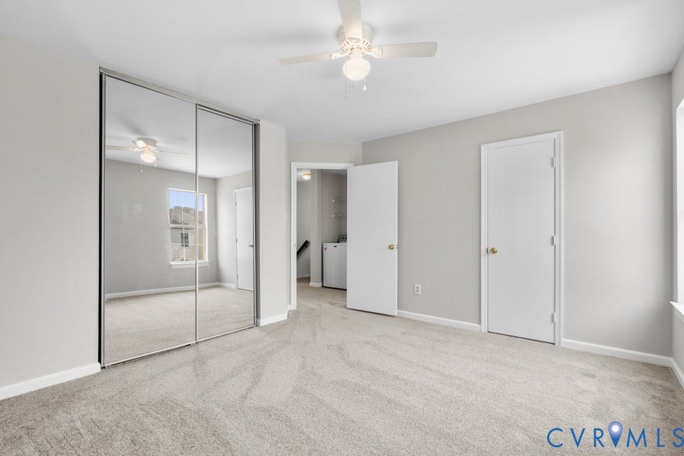 1409 Idlewood Avenue, Randolph, Richmond, VA 23220 New carpeted interior space with light gray walls, featuring a mirrored closet, a ceiling fan, and white trim