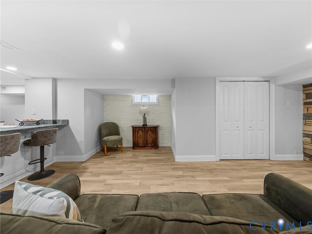 2911 Northumberland Avenue, Northside, Richmond, VA 23220 Spacious room featuring light wood-finish flooring, recessed lighting, and a partial stone accent wall
