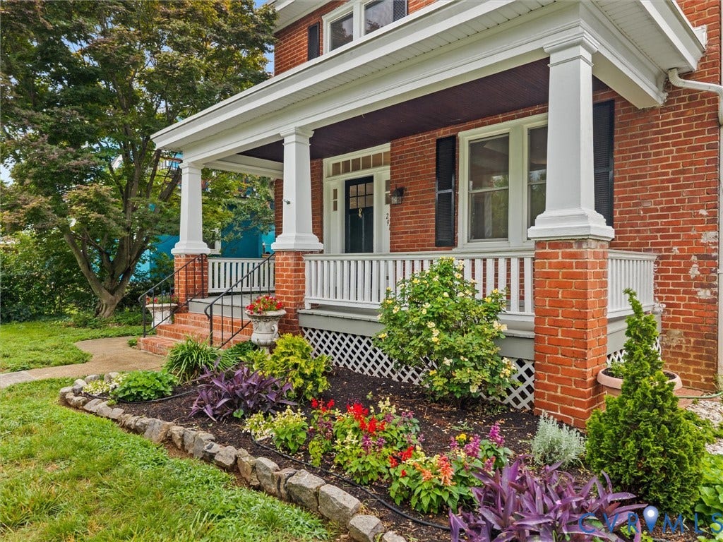 2911 Northumberland Avenue, Northside, Richmond, VA 23220 Brick exterior featuring a covered porch with white columns, a white railing, and a dark front door