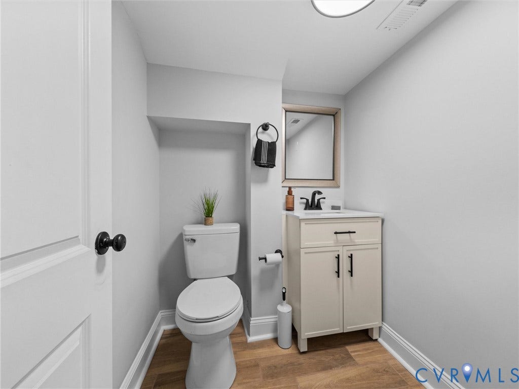 2911 Northumberland Avenue, Northside, Richmond, VA 23220 Compact powder room featuring wood-finish flooring and light gray wall paint
