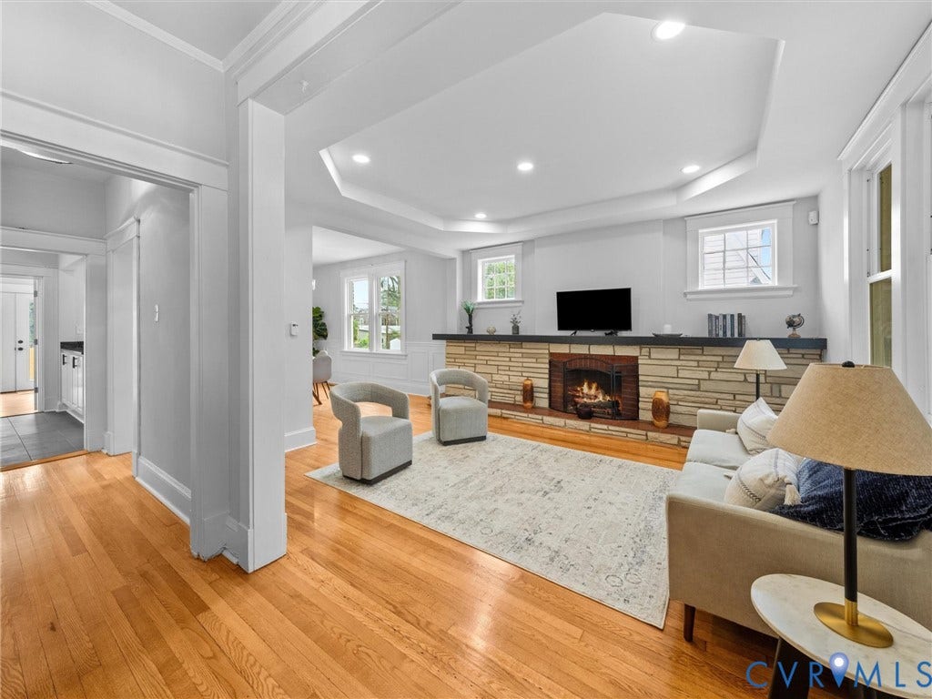 2911 Northumberland Avenue, Northside, Richmond, VA 23220 Spacious living area featuring hardwood flooring, a stone-front fireplace with a dark mantel, recessed lighting, and a tray ceiling