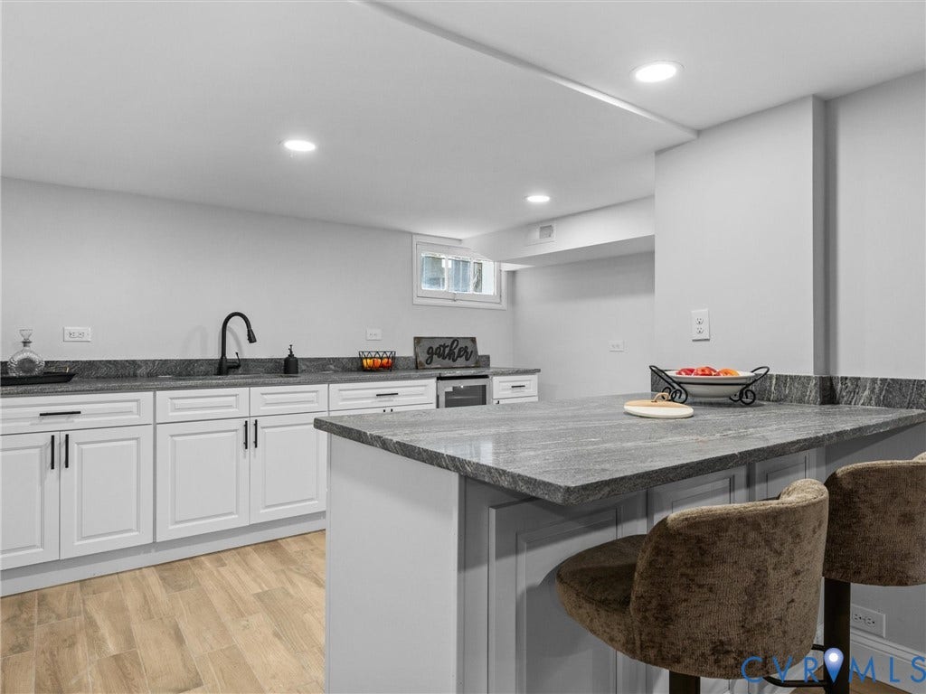 2911 Northumberland Avenue, Northside, Richmond, VA 23220 Kitchenette featuring a peninsula with seating, recessed lighting, wood-finish flooring, white cabinetry with black hardware, and a matte black faucet