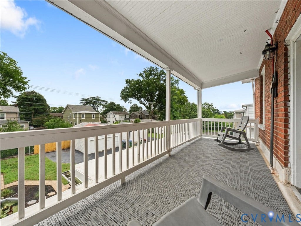 2911 Northumberland Avenue, Northside, Richmond, VA 23220 Covered porch featuring a red brick exterior wall, white wood railing, and a patterned floor surface
