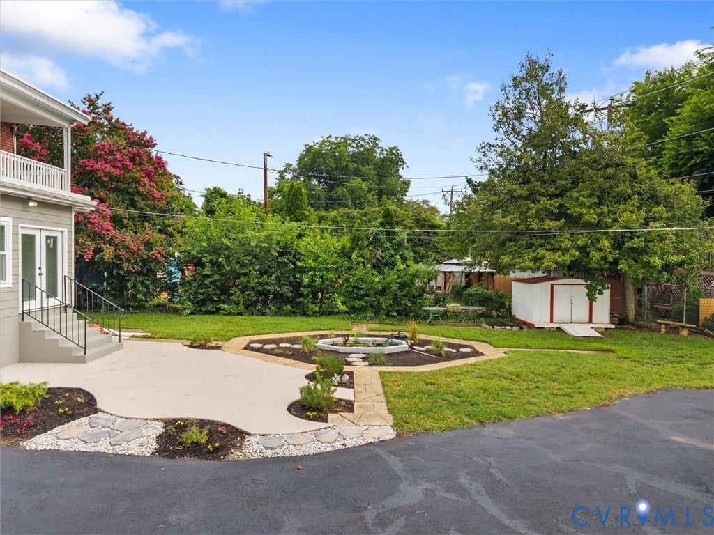 2911 Northumberland Avenue, Northside, Richmond, VA 23220 Expansive backyard featuring a concrete patio, stepping stones, and manicured lawn