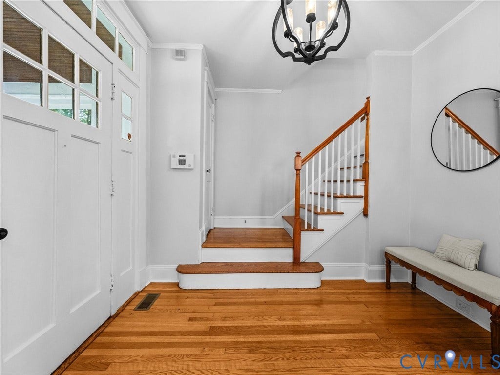 2911 Northumberland Avenue, Northside, Richmond, VA 23220 Hardwood flooring extends throughout the entry, featuring a staircase with wood treads and a white baluster railing
