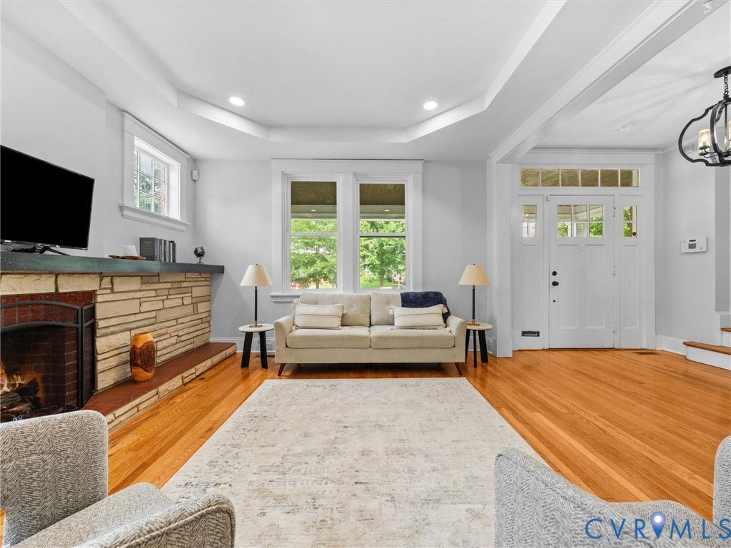 2911 Northumberland Avenue, Northside, Richmond, VA 23220 Spacious living area featuring hardwood flooring, a stone-clad fireplace, and bright windows