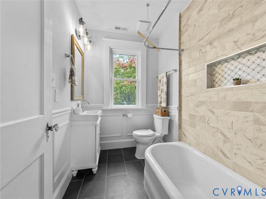 2911 Northumberland Avenue, Northside, Richmond, VA 23220 Bathroom featuring dark tile flooring, white wainscoting, and a window with natural light