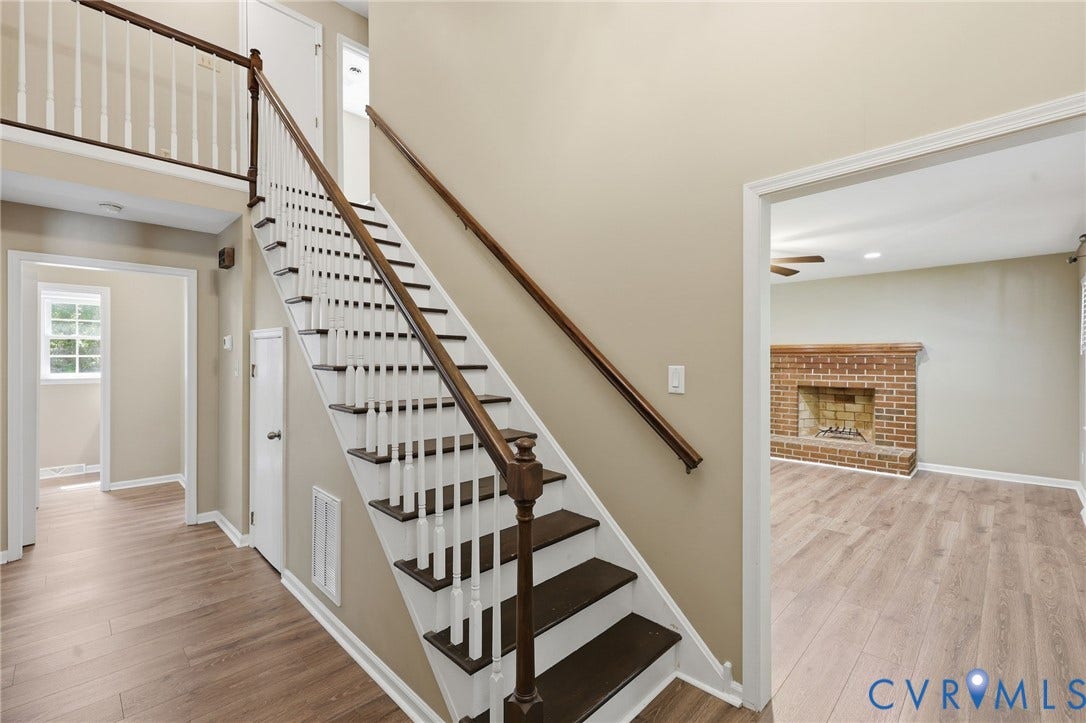 Two-story foyer with wood-finish flooring