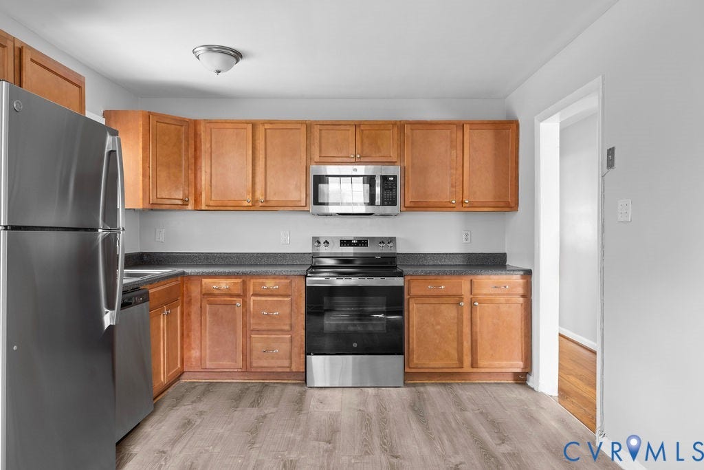5527 Hansdale Road, Piney Knolls, Richmond, VA 23224 Kitchen featuring wood-finish cabinetry, dark countertops, and stainless steel appliances