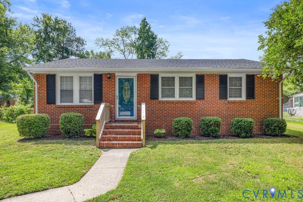 5527 Hansdale Road, Piney Knolls, Richmond, VA 23224 Brick exterior residence featuring a dark shingle roof and black window shutters