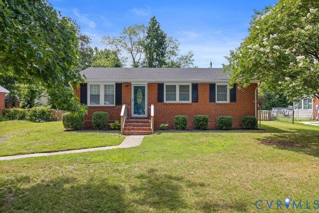5527 Hansdale Road, Piney Knolls, Richmond, VA 23224 Brick ranch-style home featuring a dark shingle roof, black louvered shutters, and a front entry with brick steps and white railings