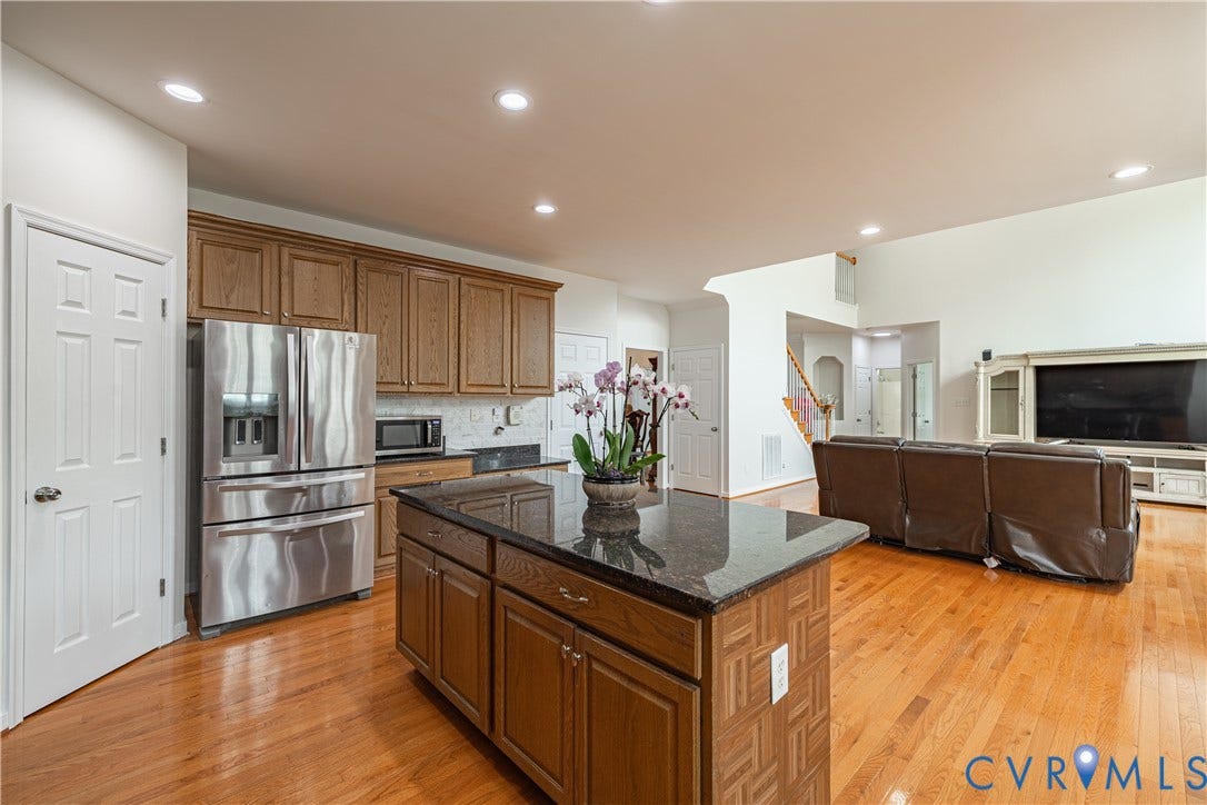 16814 Jennway Place, Moseley, VA 23120 Kitchen island with a dark countertop and wood-finish cabinetry
