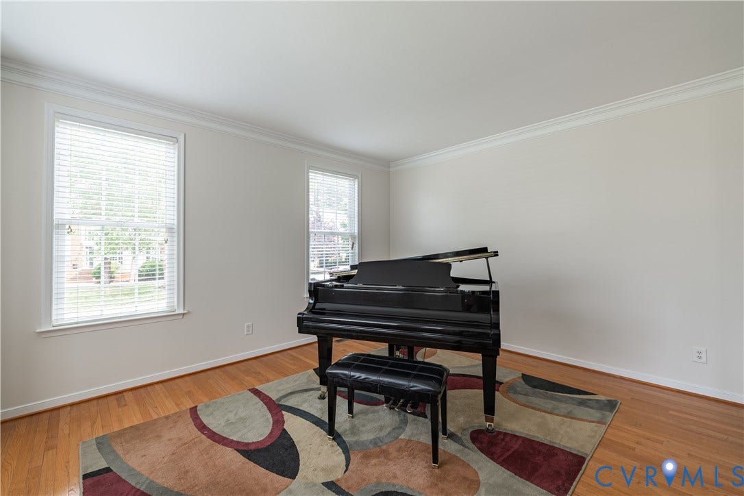 16814 Jennway Place, Moseley, VA 23120 Bright room featuring hardwood flooring, white walls, two double-hung windows with blinds, and white crown molding