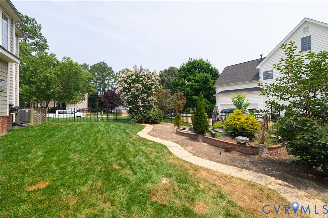 16814 Jennway Place, Moseley, VA 23120 Expansive outdoor space featuring a manicured lawn, a paved pathway, and established landscaping