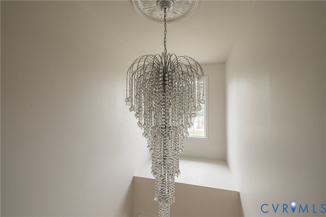 16814 Jennway Place, Moseley, VA 23120 Tiered crystal chandelier with a decorative ceiling medallion