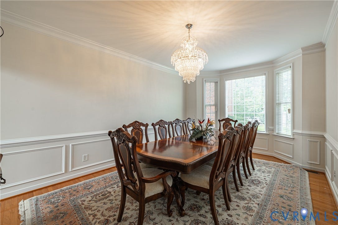 16814 Jennway Place, Moseley, VA 23120 Formal dining space featuring a tiered crystal chandelier and hardwood flooring