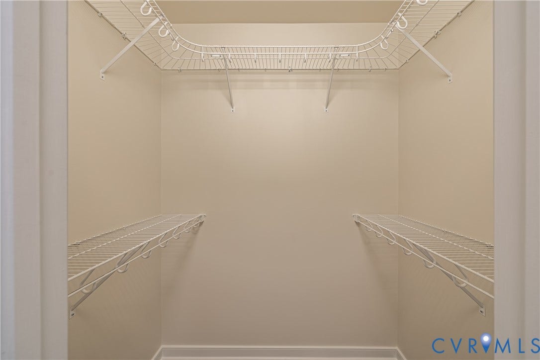 16814 Jennway Place, Moseley, VA 23120 Walk-in closet featuring light beige walls, white baseboards, and a comprehensive white wire shelving system