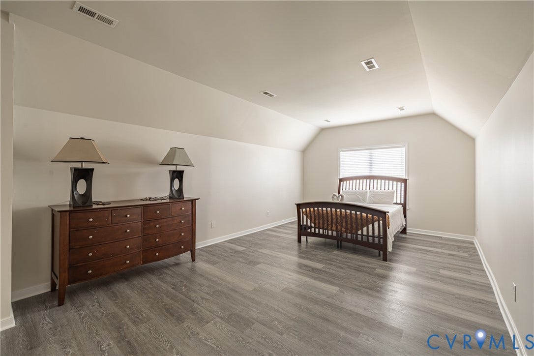 16814 Jennway Place, Moseley, VA 23120 Spacious room featuring vaulted ceilings, a window with blinds, recessed lighting, and wood-finish flooring
