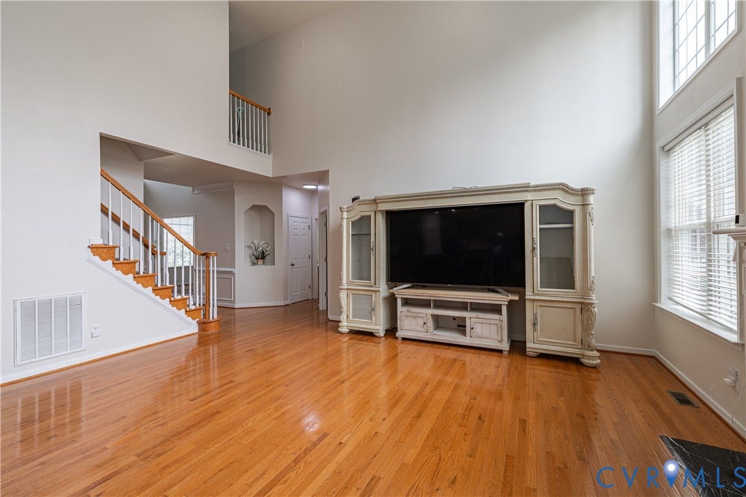 16814 Jennway Place, Moseley, VA 23120 Open-concept living space featuring high ceilings and wood-finish flooring