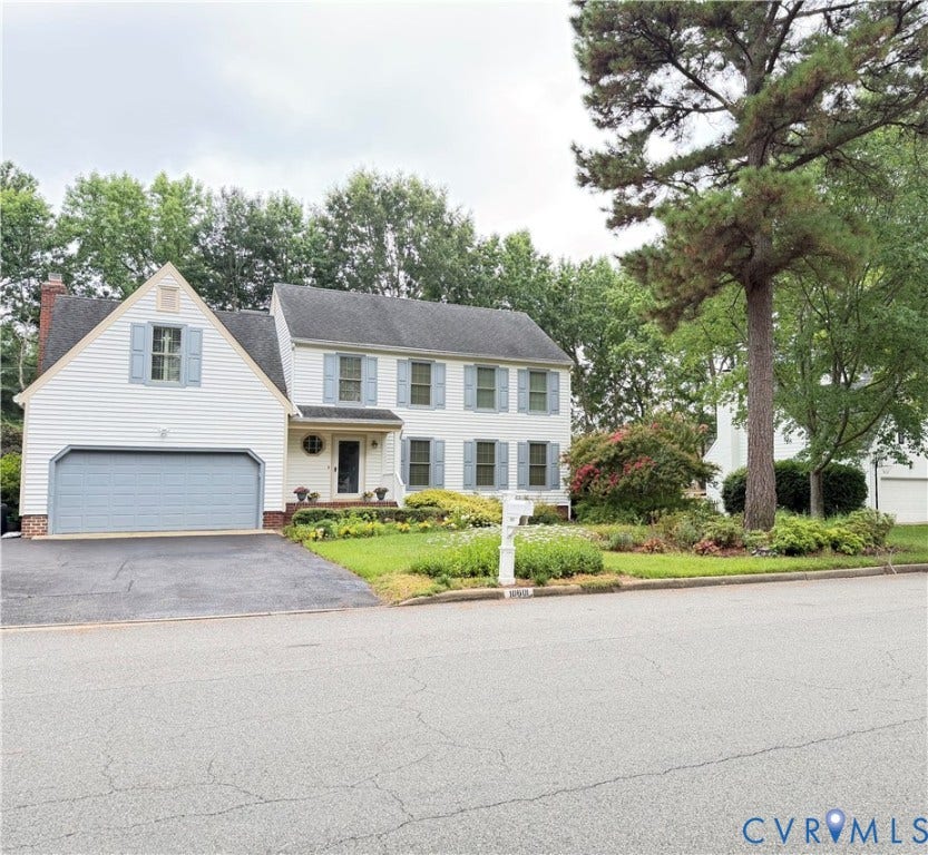 10601 Argonne Drive, Innsbrook, Glen Allen, VA 23060 White siding exterior with light blue functional shutters, an attached two-car garage, and mature landscaping