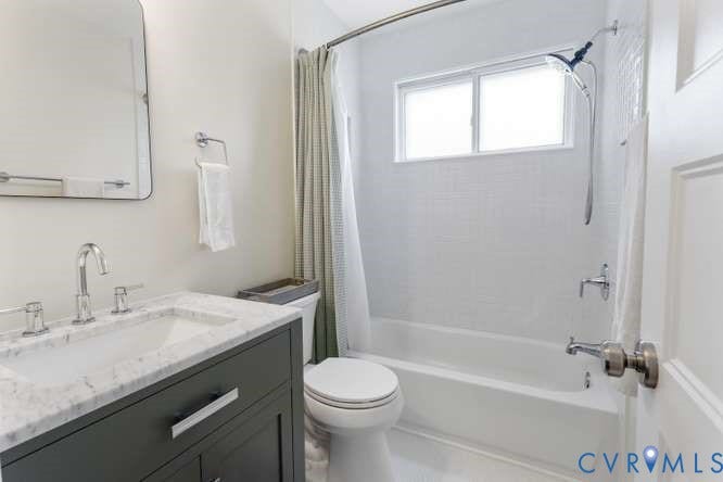 Bathroom featuring a dark wood vanity with a white stone countertop, undermount sink, and polished chrome fixtures