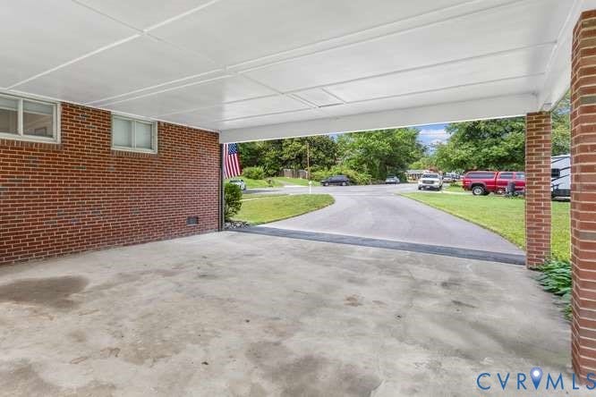 Concrete carport with a white panel ceiling, providing covered parking