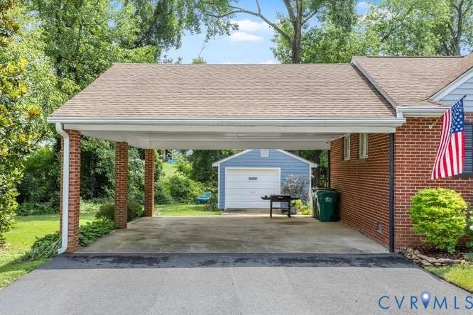 Carport with brick columns and asphalt shingle roof