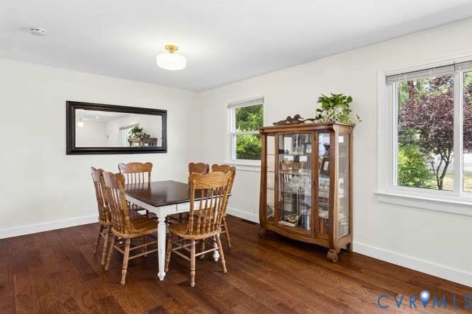Hardwood-style flooring throughout, smooth white walls, recessed lighting, and multiple windows providing natural illumination