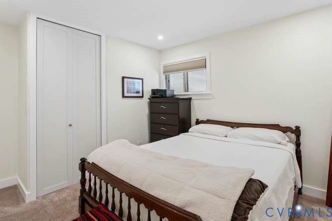 Bedroom featuring light-colored walls, recessed lighting, and carpet flooring