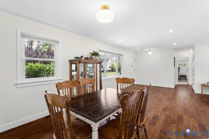 Bright dining space featuring wood-finish flooring, white walls, and recessed lighting
