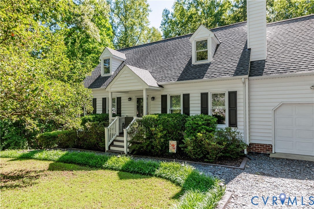 4419 Boones Bluff Way, Chesterfield, VA 23832 White siding exterior with a covered porch entry, dormer windows, and dark shutters