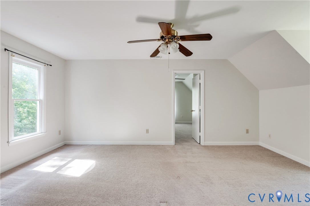 4419 Boones Bluff Way, Chesterfield, VA 23832 Spacious room featuring neutral carpet flooring, a ceiling fan with light fixture, and a window with exterior foliage visible