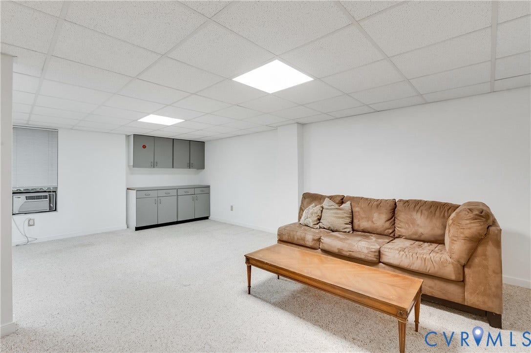 4419 Boones Bluff Way, Chesterfield, VA 23832 Finished interior space featuring textured light-colored carpet, a drop ceiling with integrated lighting, and built-in gray cabinetry with ample storage