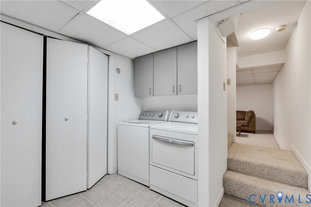 4419 Boones Bluff Way, Chesterfield, VA 23832 Laundry area featuring tiled flooring, overhead cabinetry, and bi-fold closet doors