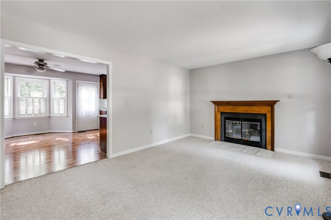4419 Boones Bluff Way, Chesterfield, VA 23832 Living area featuring a wood-mantled fireplace with a tile hearth