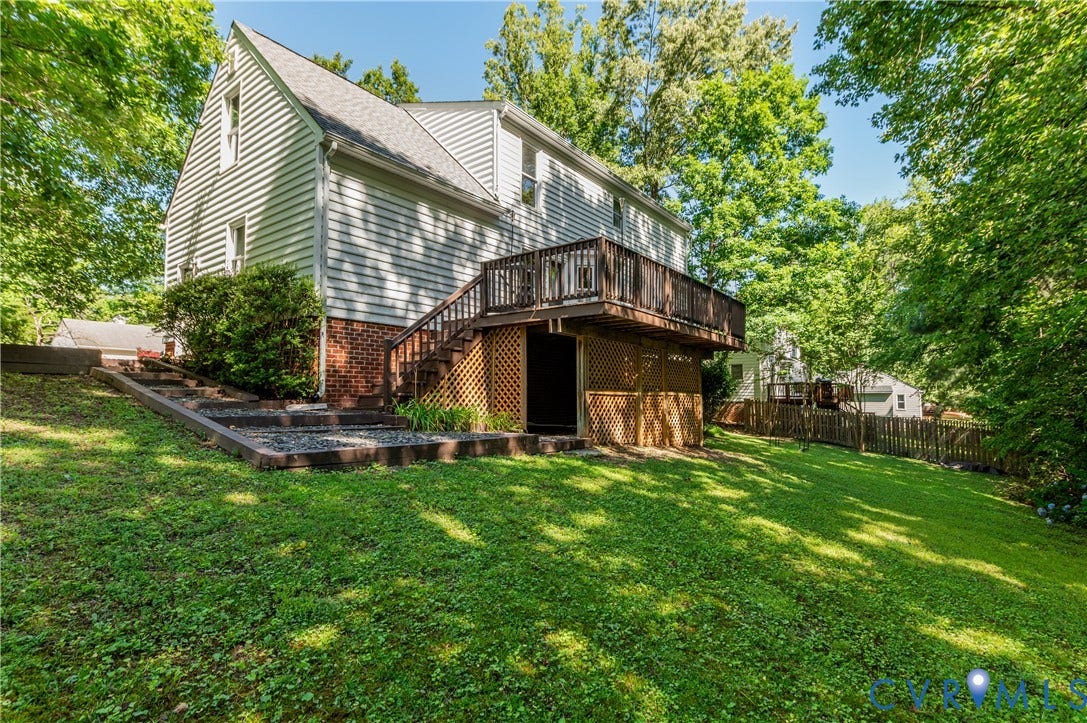 4419 Boones Bluff Way, Chesterfield, VA 23832 Expansive lawn with mature trees and a multi-level deck featuring wood railings and stairs