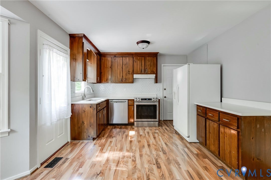 4419 Boones Bluff Way, Chesterfield, VA 23832 Kitchen featuring wood-finish flooring, wood cabinetry, white subway tile backsplash, stainless steel appliances, and white countertops