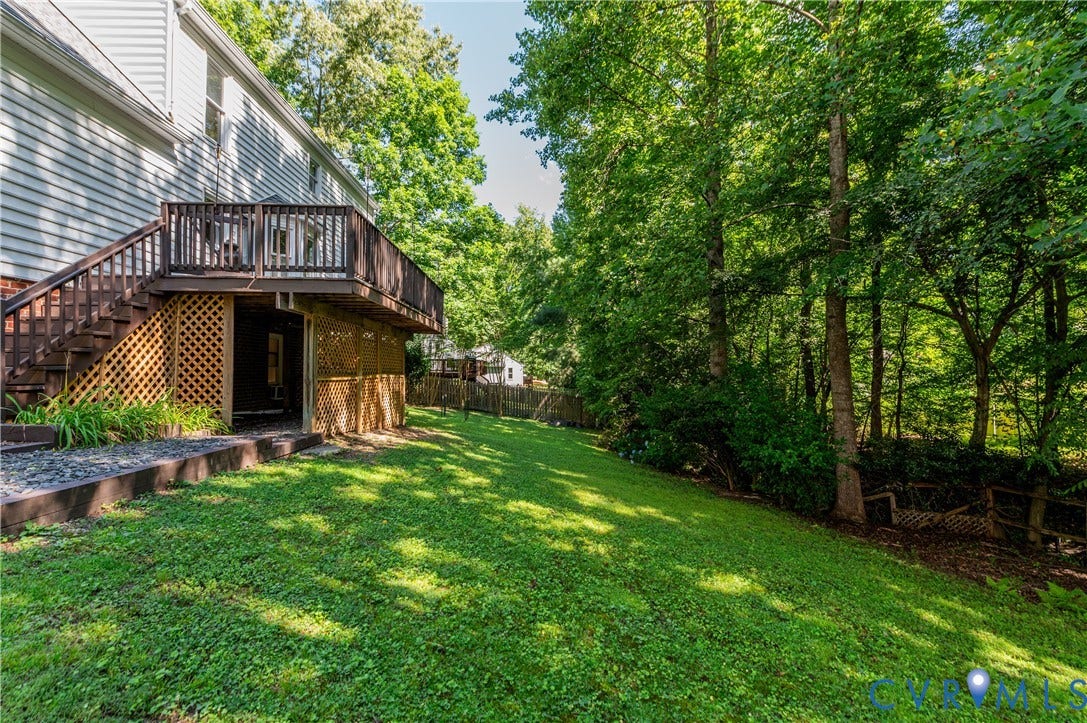 4419 Boones Bluff Way, Chesterfield, VA 23832 Expansive rear yard featuring a manicured lawn, established landscaping, and mature trees