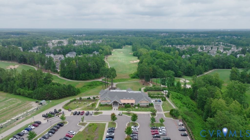 6991 Carden Park Drive, Carden Park, Moseley, VA 23120 Expansive golf course community featuring a clubhouse with extensive parking, manicured fairways, and residential properties nestled among mature trees