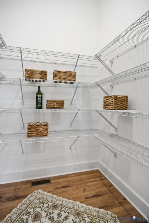 6991 Carden Park Drive, Carden Park, Moseley, VA 23120 Corner pantry featuring wire shelving, wood-finish flooring, and white baseboards