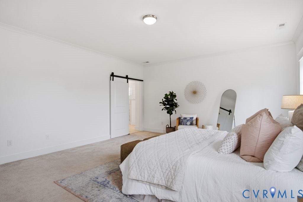 6991 Carden Park Drive, Carden Park, Moseley, VA 23120 Bright bedroom with crown molding, recessed lighting, and a modern barn door