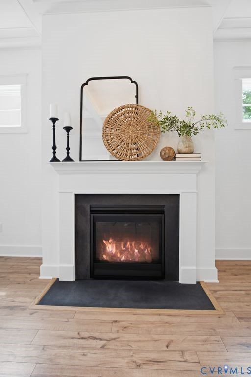 6991 Carden Park Drive, Carden Park, Moseley, VA 23120 White mantel with a dark gray hearth, gas fireplace insert, wood-finish flooring, and white trim